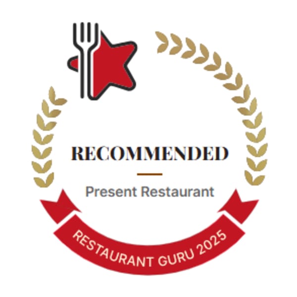 Restaurant Guru 2025 Recommended badge for Present Restaurant, featuring a red star, fork, and laurel wreath.