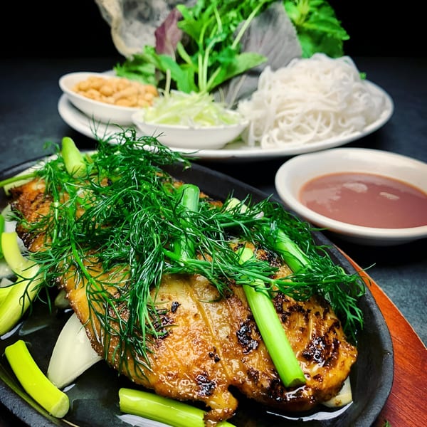 Vietnamese Cha Ca La Vong with fish, dill, scallions, noodles, peanuts, and dipping sauce.