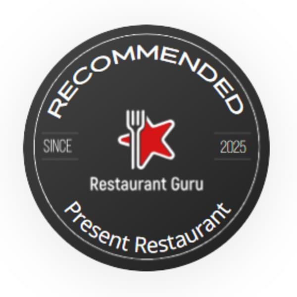 Restaurant Guru Recommended badge for Present Restaurant, featuring a fork and red star icon.